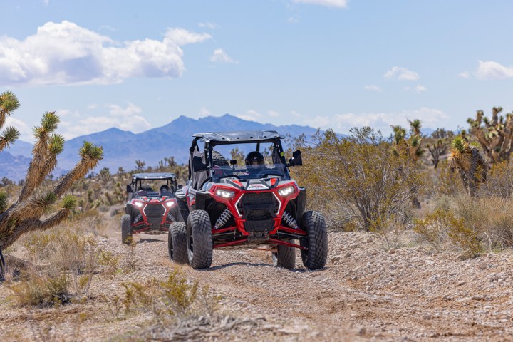 a truck driving down a dirt road